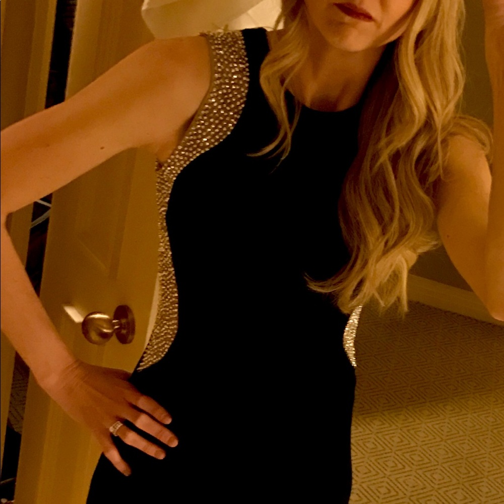 Illusion panels contrast along the sides of Xscape's cocktail dress. 
Black/nude